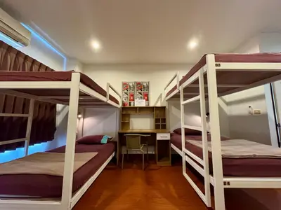 a room with three bunk beds and a desk at Ananas Central Phuket Hostel in Ban Ket Ho