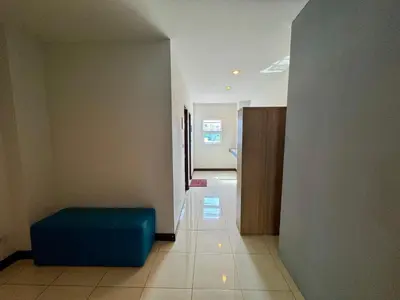 a hallway with a blue ottoman in a room at Ananas Central Phuket Hostel in Ban Ket Ho