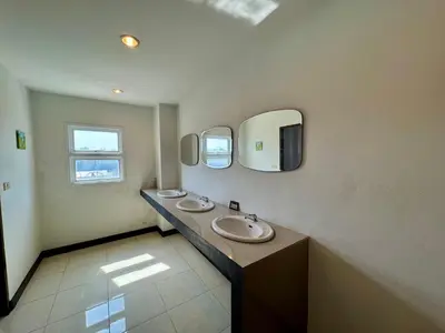 a bathroom with two sinks and two mirrors at Ananas Central Phuket Hostel in Ban Ket Ho