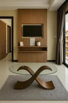 a living room with a television and a large bronze sculpture at 1 bedroom Naiharn Beach Condo in Rawai Beach