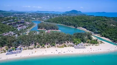 an aerial view of a beach with people on it at 1 bedroom Naiharn Beach Condo in Rawai Beach
