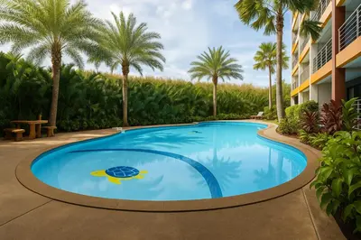 a swimming pool with a turtle in the middle at 1 bedroom Naiharn Beach Condo in Rawai Beach