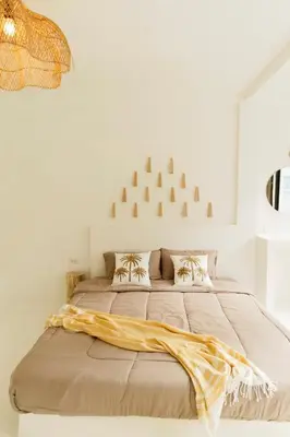 a bedroom with a large bed with a blanket on it at The hidden home in Patong Beach