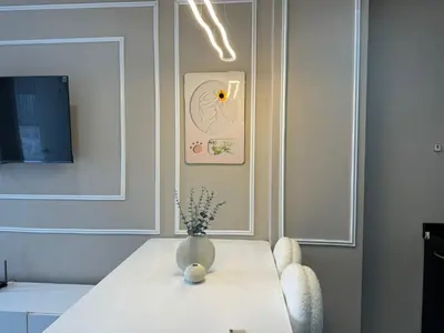 a white table with a vase on top of it at Condo for rent chalong rawai 305 in Ban Klang