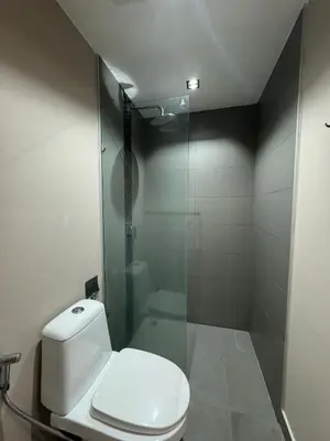 a bathroom with a toilet and a glass shower at Condo for rent chalong rawai 305 in Ban Klang