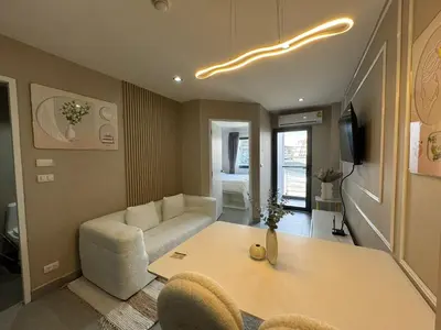 a living room with a table and a couch at Condo for rent chalong rawai 305 in Ban Klang