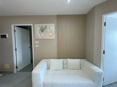a living room with a white couch in a room at Condo for rent chalong rawai 305 in Ban Klang