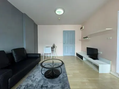 a living room with a black couch and a table at Dcondo kathu phuket in Kathu