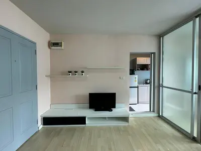 a living room with a flat screen tv on a table at Dcondo kathu phuket in Kathu