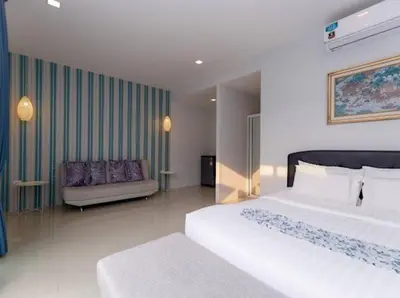 a hotel room with two beds and a couch at The COZY NATURE pool villas phuket in Koh Lone