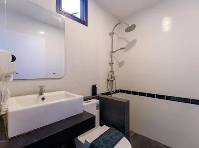 a bathroom with a sink and a toilet and a mirror at The COZY NATURE pool villas phuket in Koh Lone
