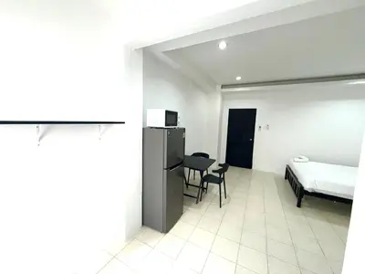 a bedroom with a bed and a table and chairs at Patong Canal Villa 110 in Patong Beach