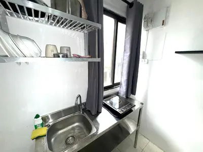 a kitchen with a sink and a window at Patong Canal Villa 110 in Patong Beach
