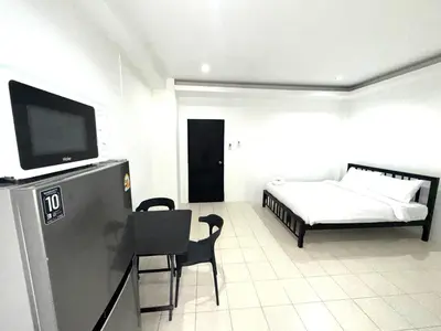 a living room with a bed and a tv in it at Patong Canal Villa 110 in Patong Beach