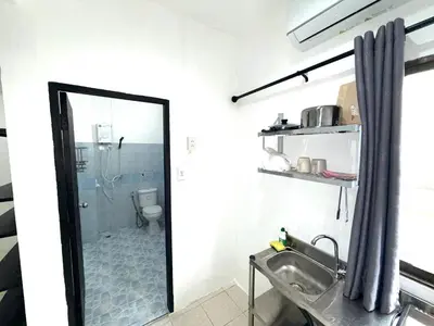 a bathroom with a mirror and a sink at Patong Canal Villa 110 in Patong Beach