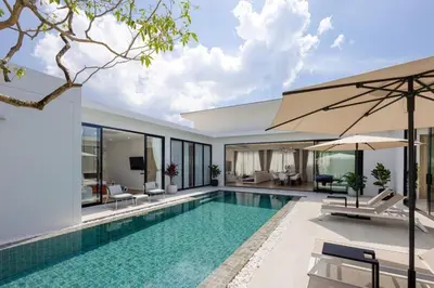 a swimming pool in a villa with a house at Le Da Villas 5BR Private Pool Villa, Bangtao Beach Phuket in Laguna Phuket