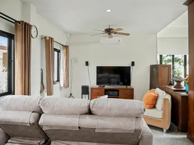 a living room with a couch and a flat screen tv at 3 Bedrooms - 2 floor with garden in Prime Location in Thalang