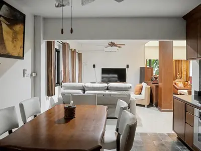 a kitchen and living room with a table and a couch at 3 Bedrooms - 2 floor with garden in Prime Location in Thalang