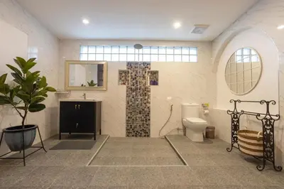 a large bathroom with a toilet and a sink at Private beachfront Villa Natai with 5 bedrooms in Ban Na Tai