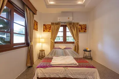 a bedroom with two beds and a window at Private beachfront Villa Natai with 5 bedrooms in Ban Na Tai