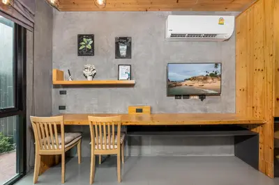 a dining room with a wooden table and chairs at Relife Apartments by Tropiclook - Fast WiFi , Pool and Gym in Phuket Town