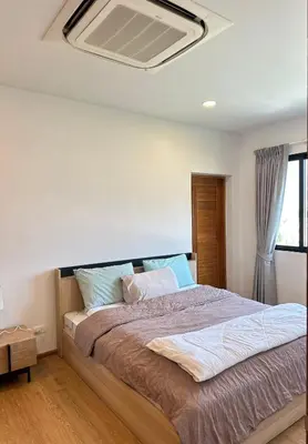 a bedroom with a large bed with a ceiling at The Passion House in Ban Na Nai