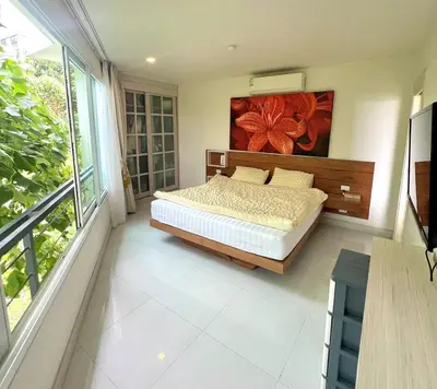 a bedroom with a bed and a painting on the wall at Sea view Karon Butterfly 2 bdr in Karon Beach