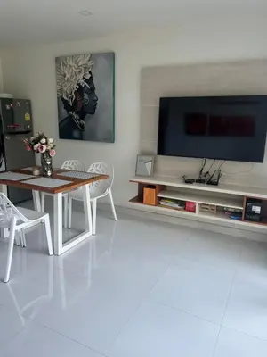 a living room with a table and a tv at Sea view Karon Butterfly 2 bdr in Karon Beach