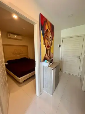 a room with a bed and a painting on the wall at Sea view Karon Butterfly 2 bdr in Karon Beach