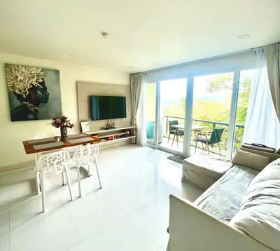 a living room with a couch and a table at Sea view Karon Butterfly 2 bdr in Karon Beach