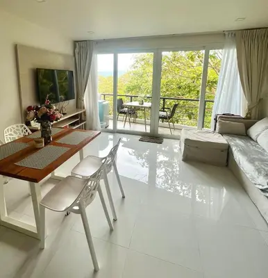 a living room with a table and a couch at Sea view Karon Butterfly 2 bdr in Karon Beach