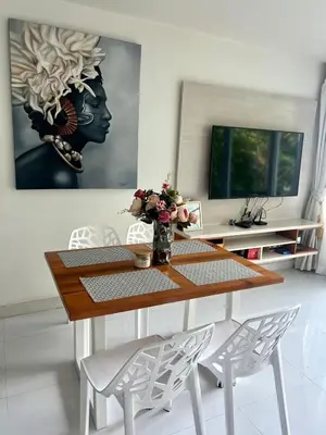 a dining room with a table and two chairs at Sea view Karon Butterfly 2 bdr in Karon Beach