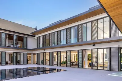an exterior view of a house with large windows at Villa Amarasara in Phuket Town
