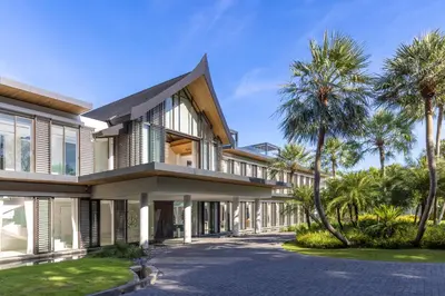 an exterior view of a house with palm trees at Villa Amarasara in Phuket Town