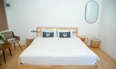 a bedroom with a large bed with blue pillows at RQ Phuket Patong Beach by Collection O in Patong Beach