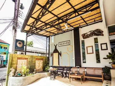 a building with a group of tables and benches at RQ Phuket Patong Beach by Collection O in Patong Beach