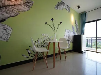 a dining room with a vase on a green wall at RQ Phuket Patong Beach by Collection O in Patong Beach