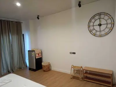 an empty room with a clock on the wall at RQ Phuket Patong Beach by Collection O in Patong Beach