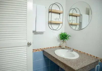 a bathroom with a sink and a mirror at RQ Phuket Patong Beach by Collection O in Patong Beach