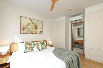 a bedroom with a white bed and a bathroom at New 1 bdr Apartment in Laguna 50m from the Beach in Bang Tao Beach