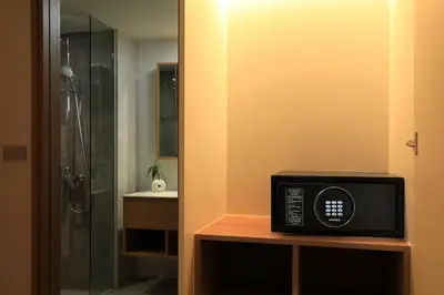 a bathroom with a shower and a microwave on a table at New 1 bdr Apartment in Laguna 50m from the Beach in Bang Tao Beach