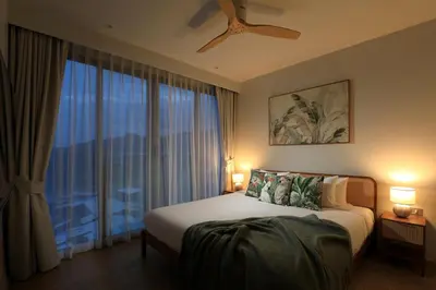 a bedroom with a bed and a large window at New 1 bdr Apartment in Laguna 50m from the Beach in Bang Tao Beach