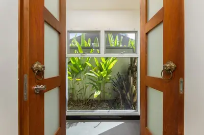 an open door with a window with a plant inside at Villa Emilia Private Pool Naiharn in Rawai Beach
