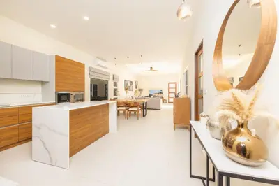a kitchen with white floors and a large mirror at Villa Emilia Private Pool Naiharn in Rawai Beach