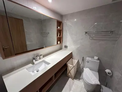 a bathroom with a sink and a toilet and a mirror at 2 bdr Apartments Laguna Beachside 50m from Bangtao Beach in Bang Tao Beach