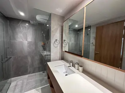 a bathroom with a sink and a shower and a mirror at 2 bdr Apartments Laguna Beachside 50m from Bangtao Beach in Bang Tao Beach