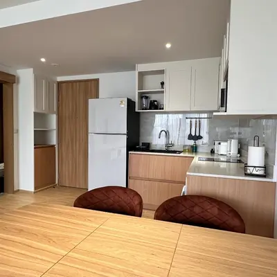 a kitchen with a table and chairs and a refrigerator at 1 bdr Mountain View Apartment 50 m from Bangtao Beach in Bang Tao Beach