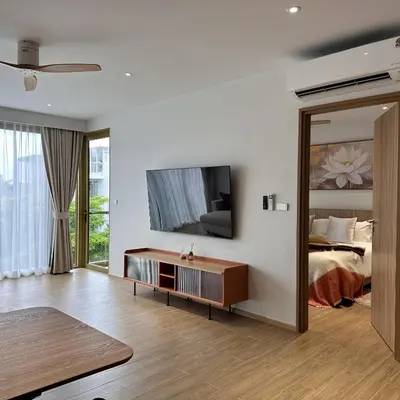 a living room with a bed and a mirror at 1 bdr Mountain View Apartment 50 m from Bangtao Beach in Bang Tao Beach
