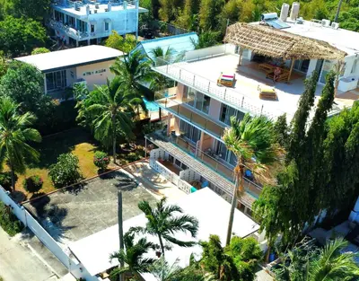 an overhead view of a building with palm trees at Phuket Arkadia Home in Nai Harn Beach