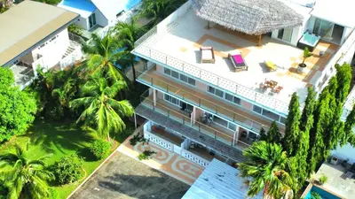 an overhead view of a building with palm trees at Phuket Arkadia Home in Nai Harn Beach